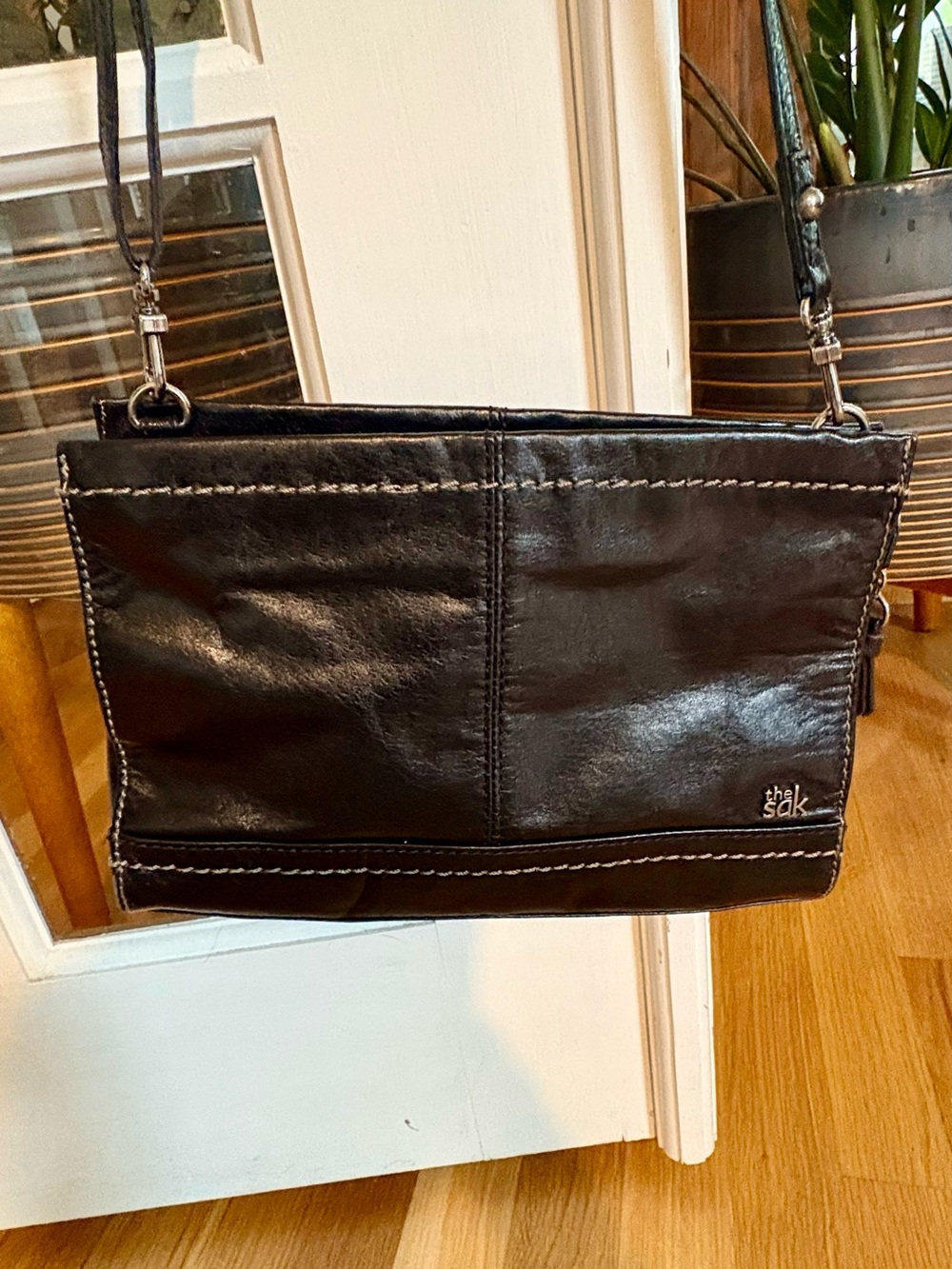 The Sak Black Leather Iris Crossbody with Patterned Orange & Green Lining